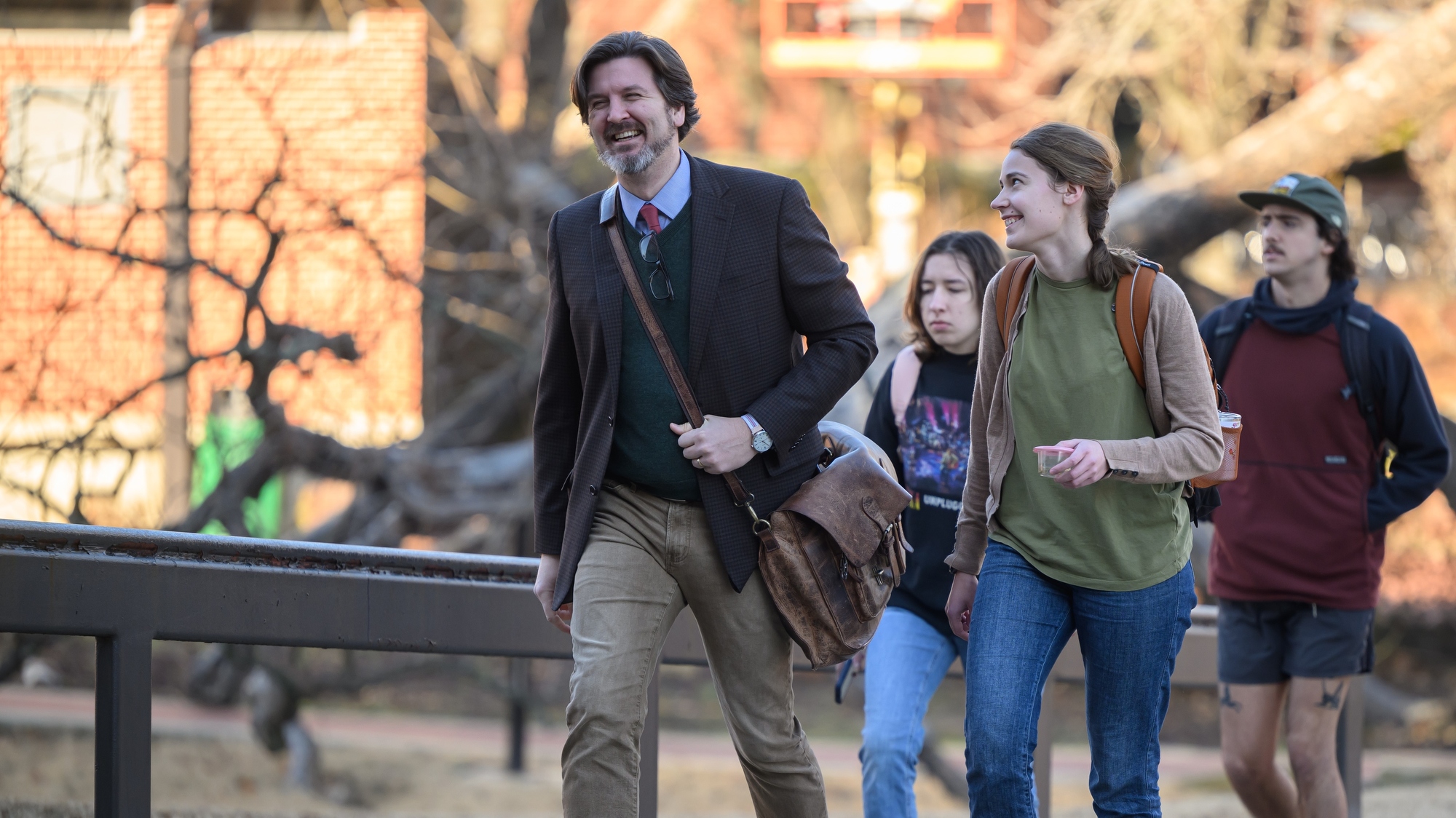 Teacher and student sharing a laugh while walking