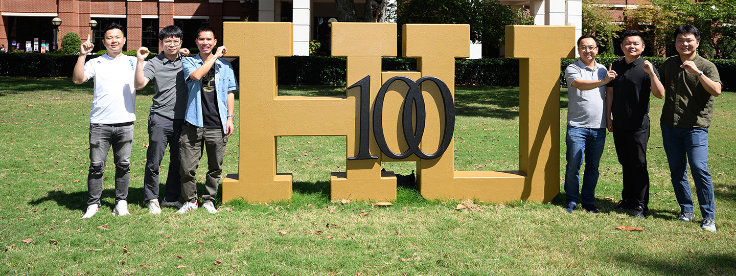 International students with the HU 100 sign out on the front lawn