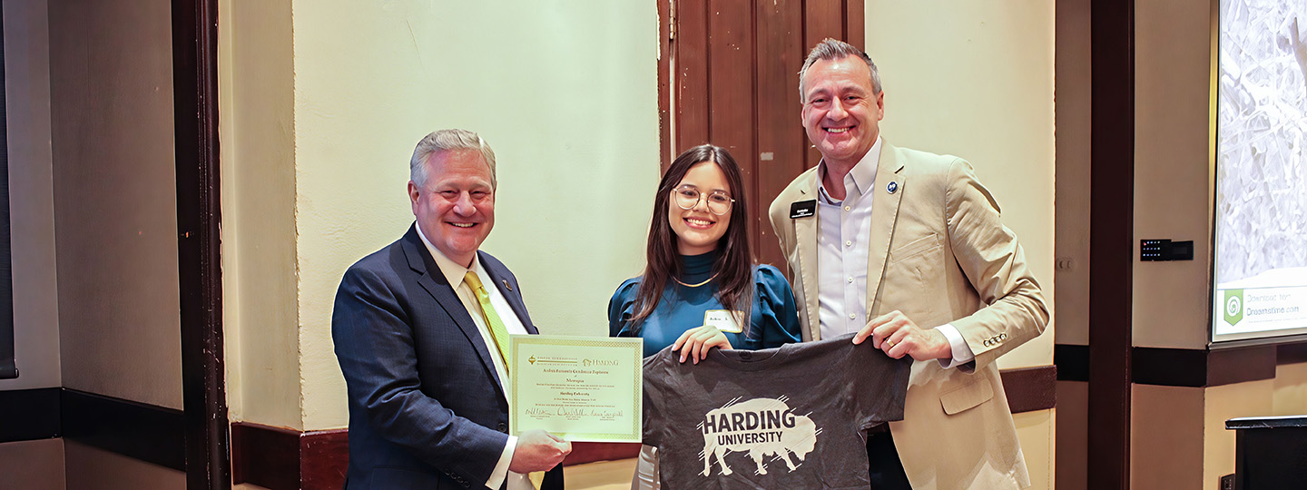 A student receiving a scholarship from the President