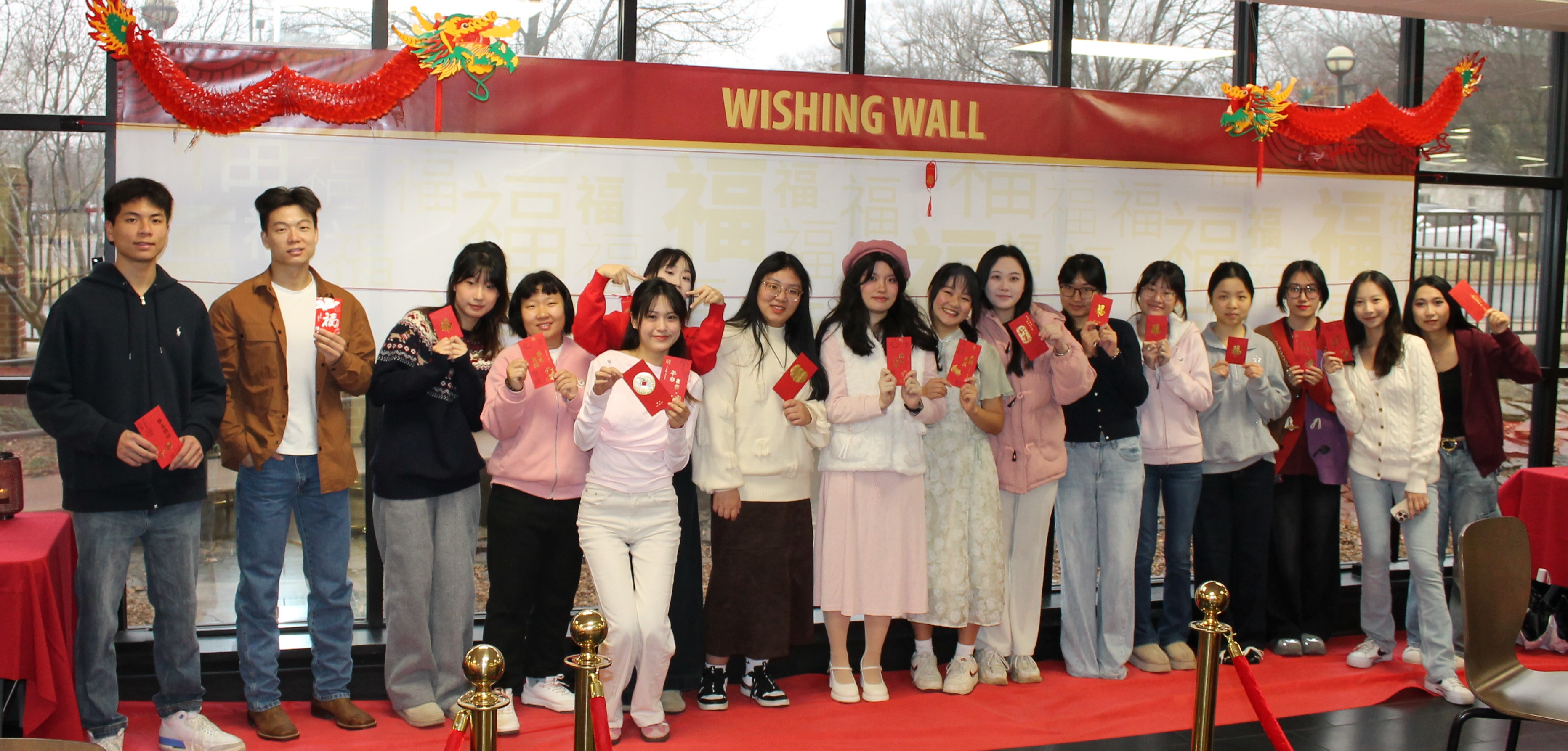 Students smiling holding item in hand
