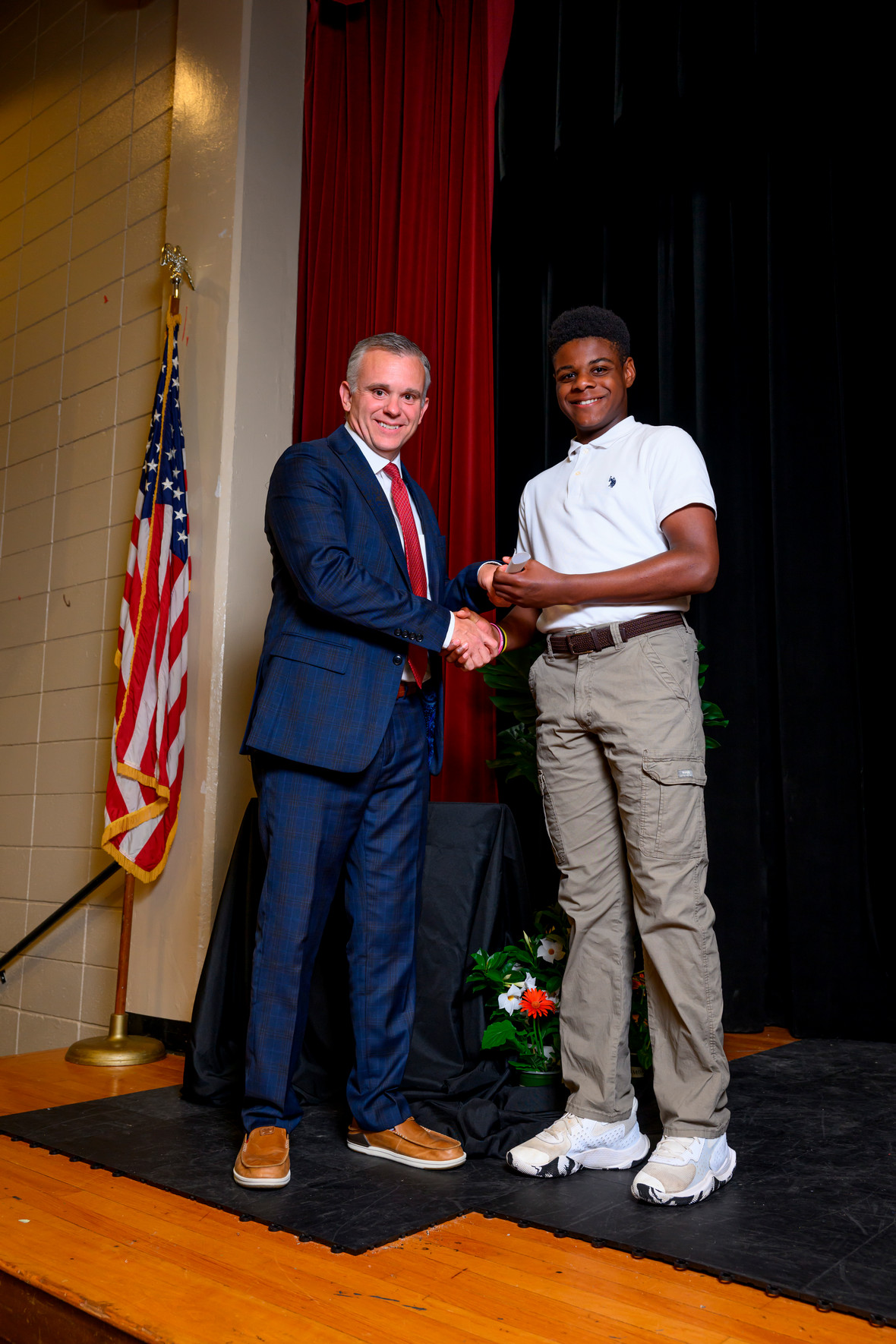 student and superintendent posing at an award ceremony