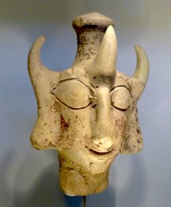 Stone statue that is a head with three horns