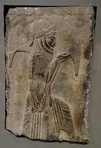 Tablet with image of attendant kneeling holding wineskin