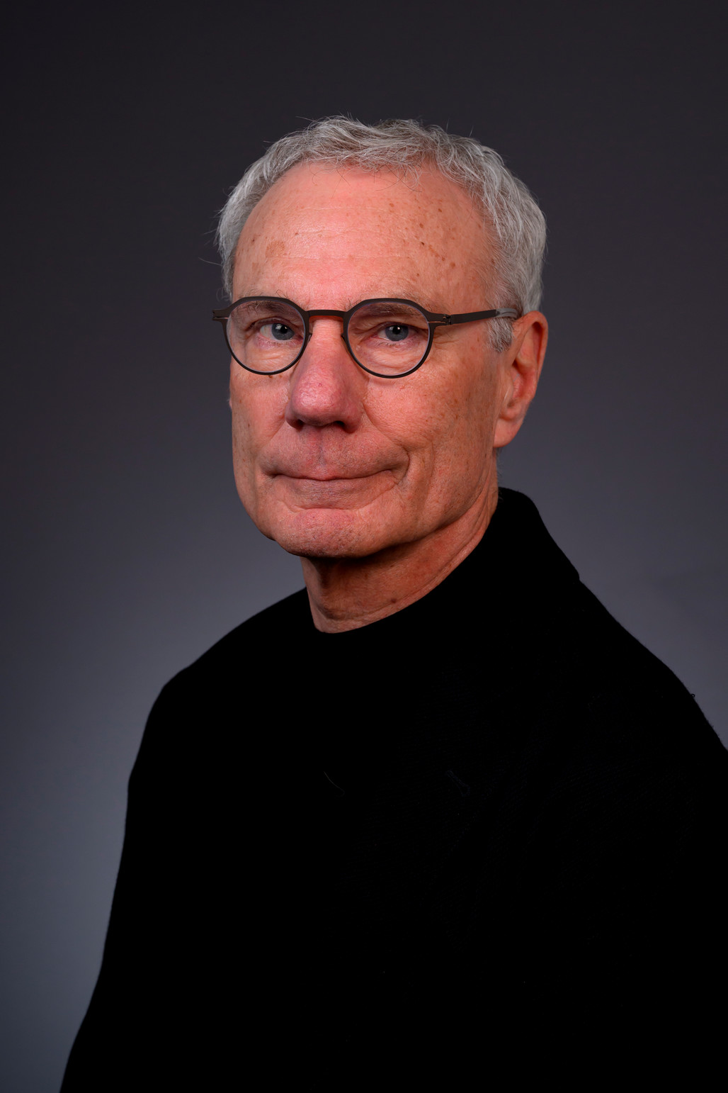 Leon Blue, a white male wiht glasses smiling for a photo.