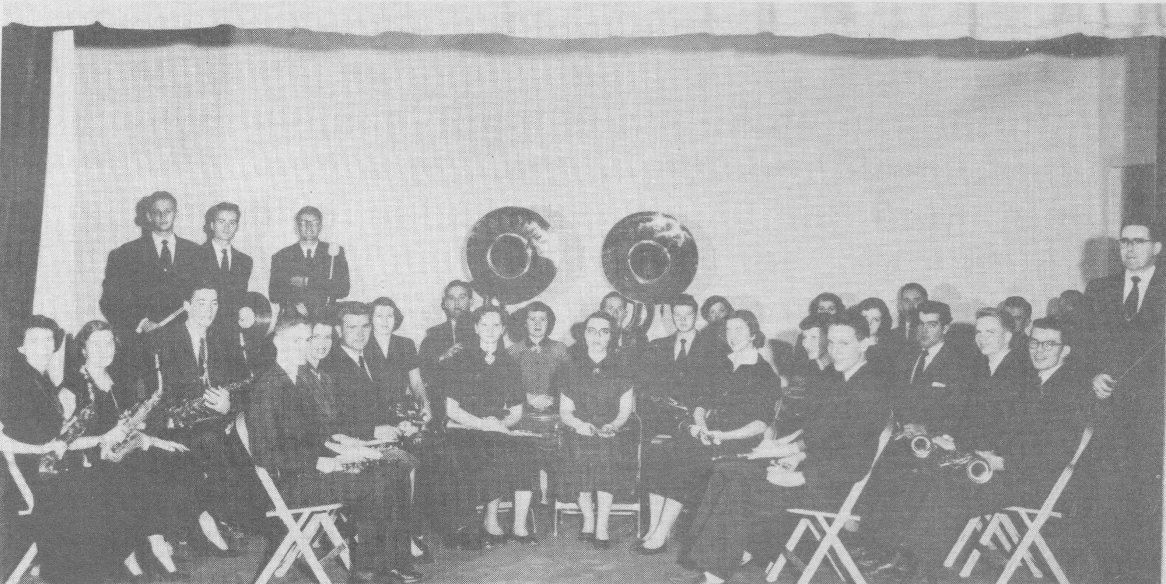 Black and white photo of the band group posing with their instruments.