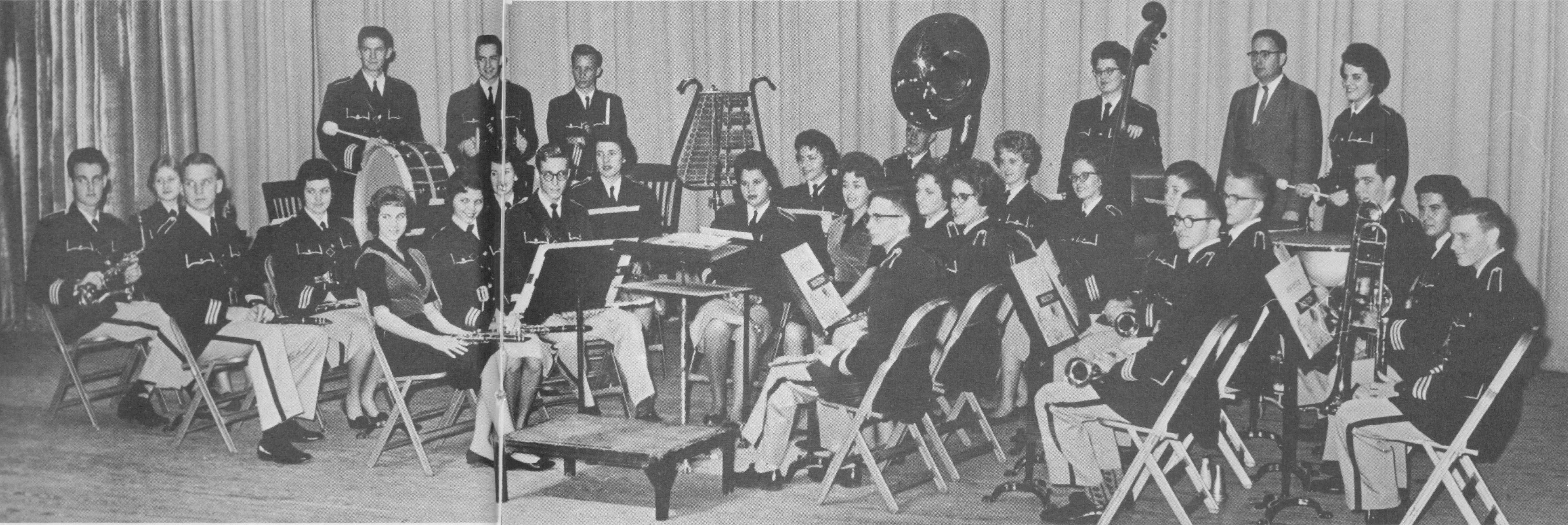 Black and white photo of the band group posing with their instruments.