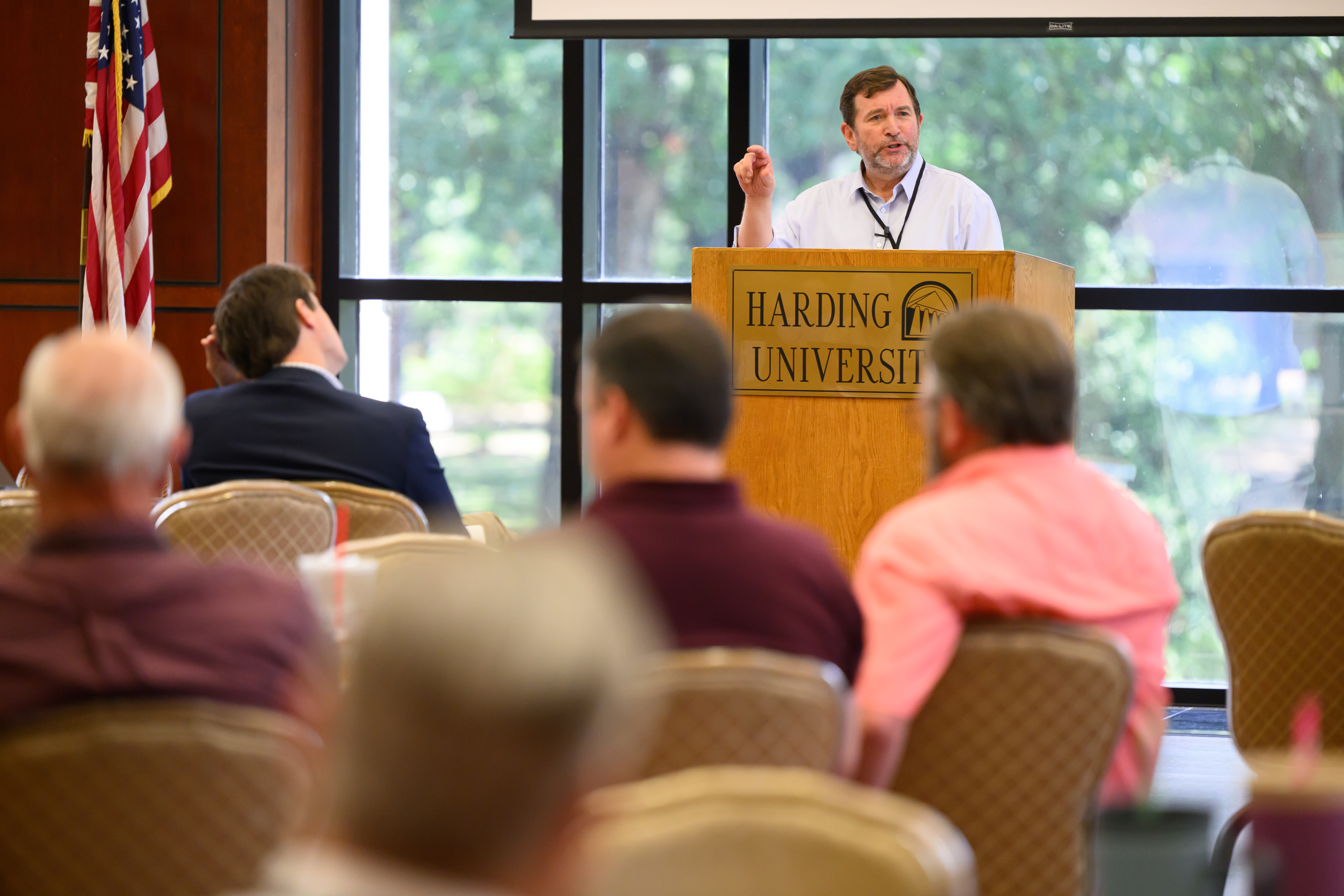 Dr. Jeff Peterson speaks at a podium while an audience listens in Cone Chapel.