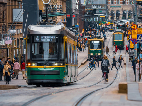 A train on a crowded street in Helsinki