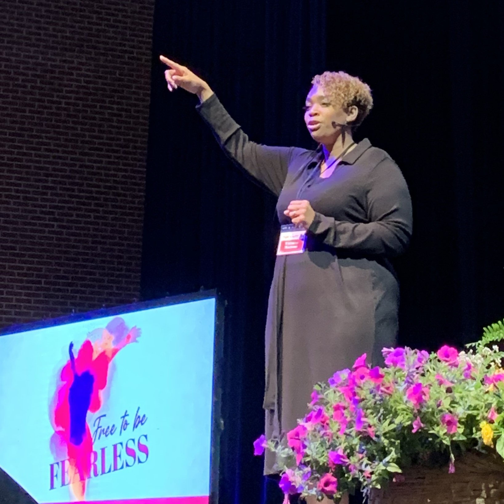 Tiffany Malone speaking on stage at Bloom 2025 conference