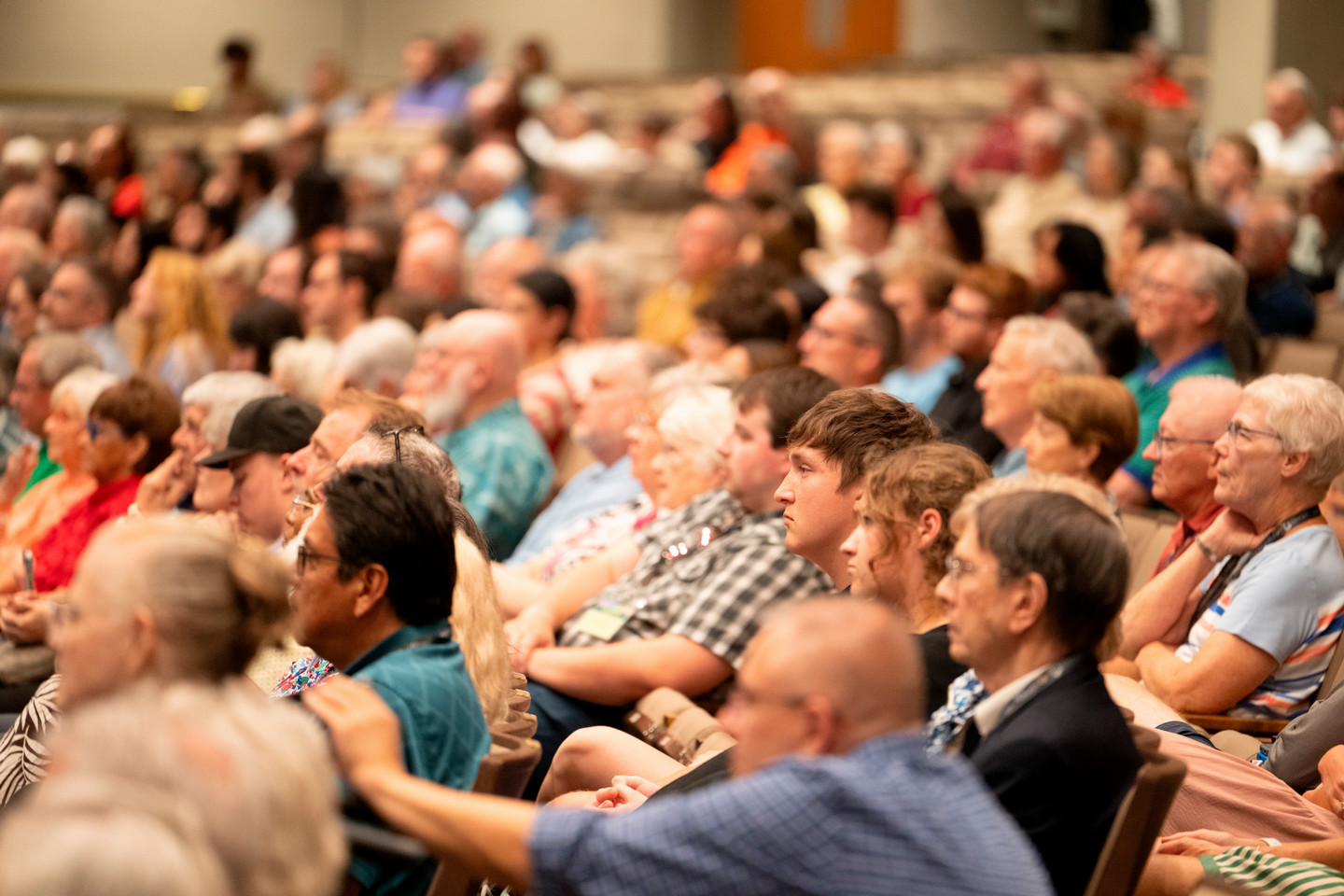 A crowd of people seated in an auditorium