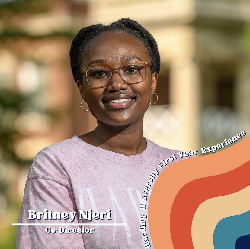 Stampede Co-Director Britney Njeri smiles in front of a colorful background