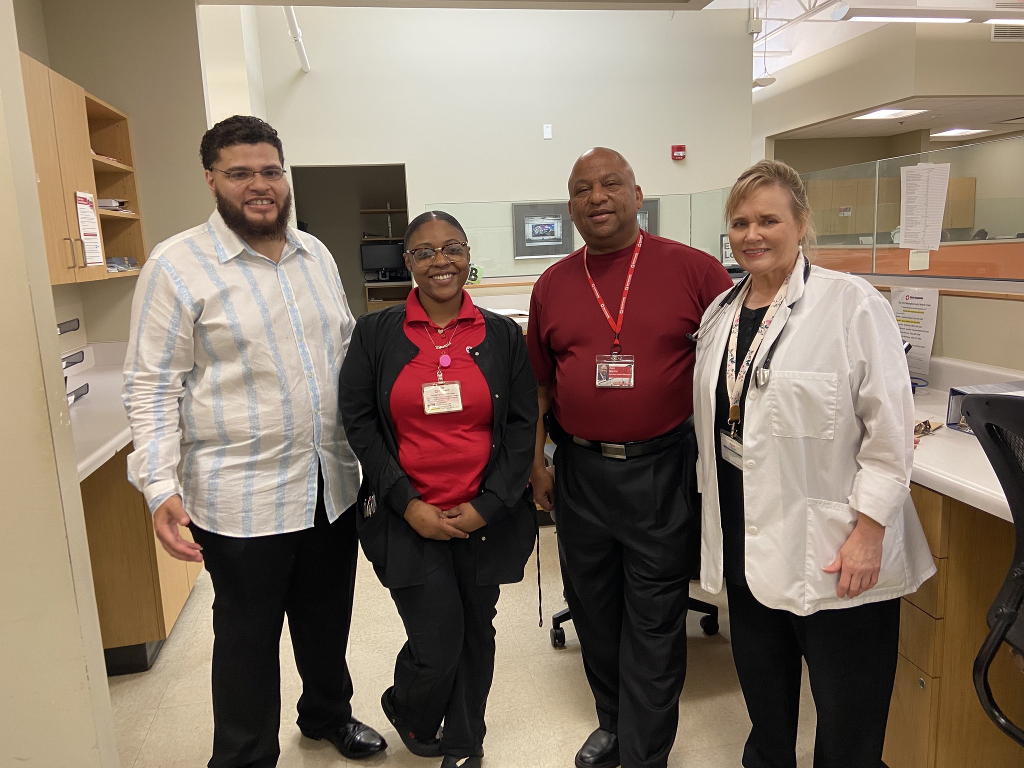 Interns smiling together for a group photo inside a health clinic.
