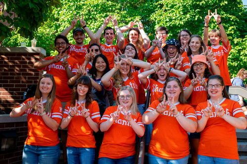 Members of the club "Shanta" are posed for a group picture to show their club sign.